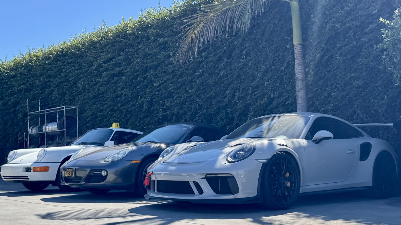 Row of performance sports cars waiting for wheel and tire service at Ron's Tire & Wheel