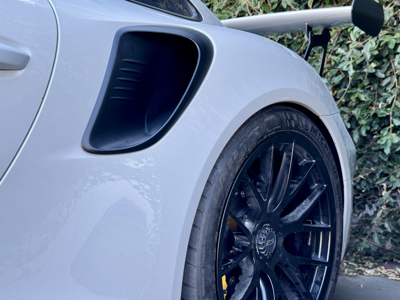 Close-up of a performance coupe's rear wheel and tire after service